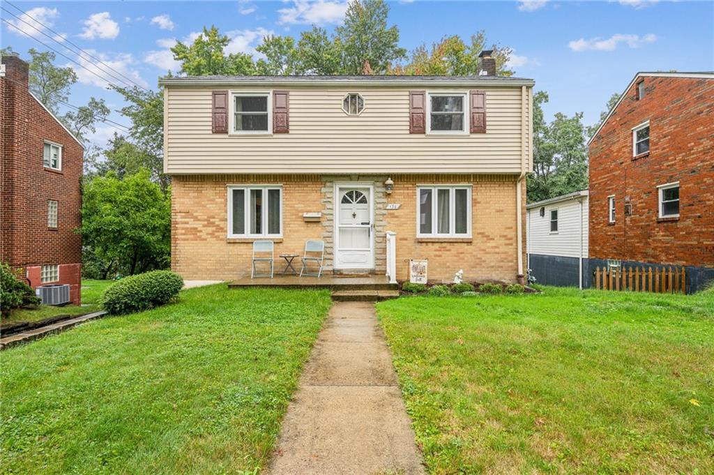 front view of a house with a yard