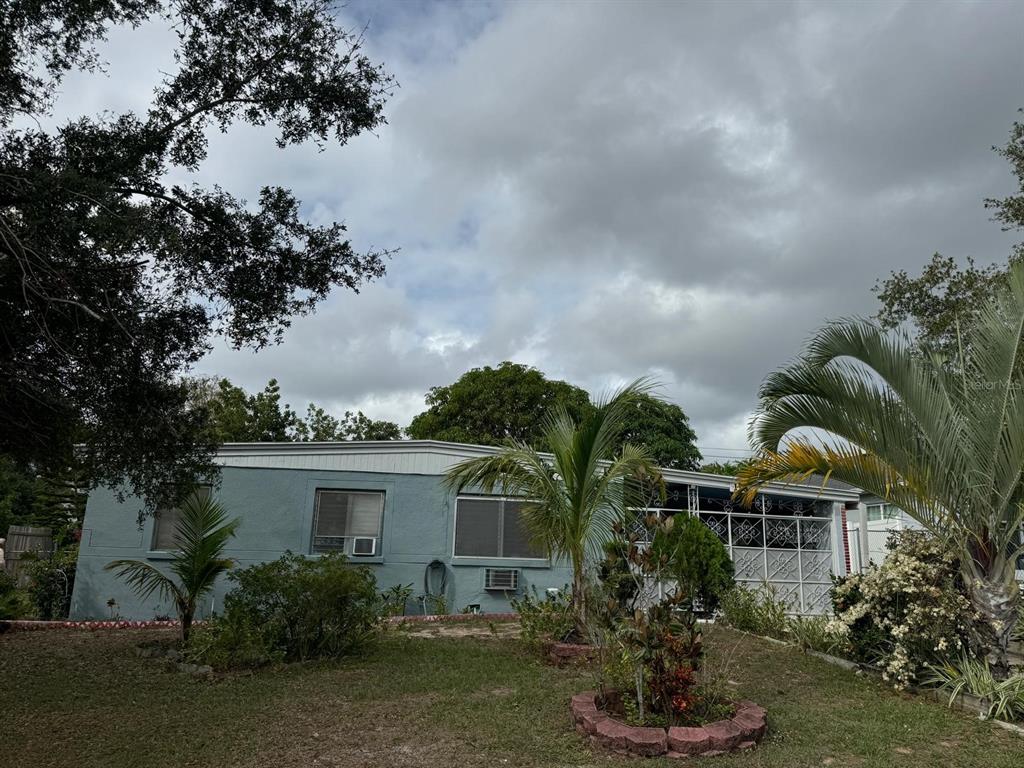 a front view of house with a garden