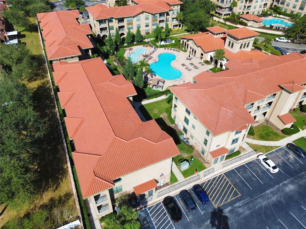 an aerial view of a house with yard swimming pool and outdoor seating