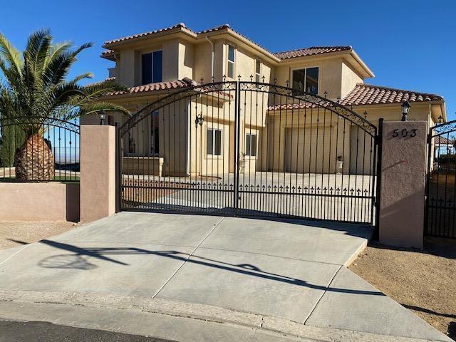 a front view of a house with a iron gate