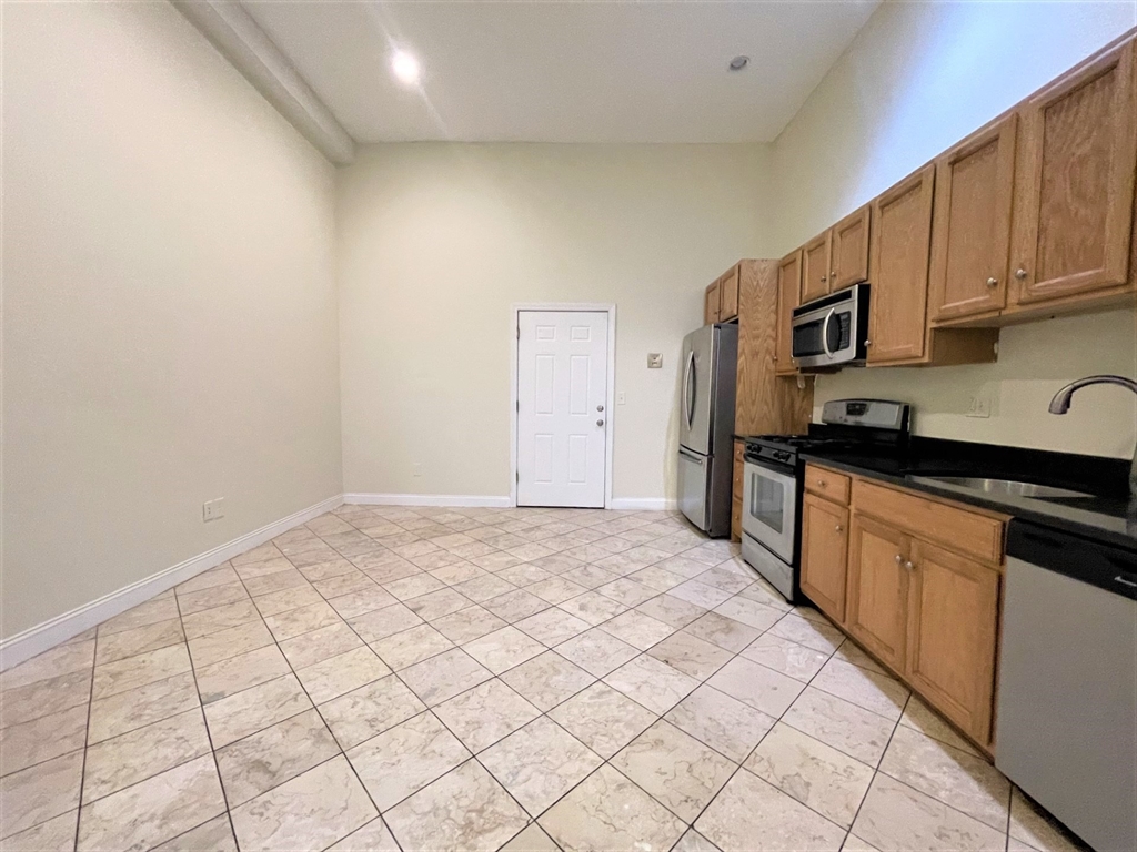 a kitchen with stainless steel appliances granite countertop a sink and cabinets