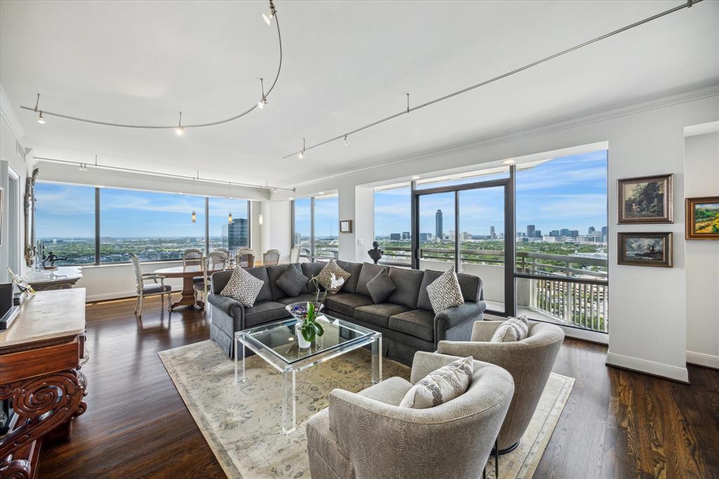 a living room with furniture and a floor to ceiling window