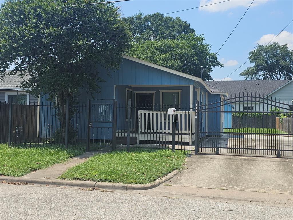 a view of a house with a backyard and a garden