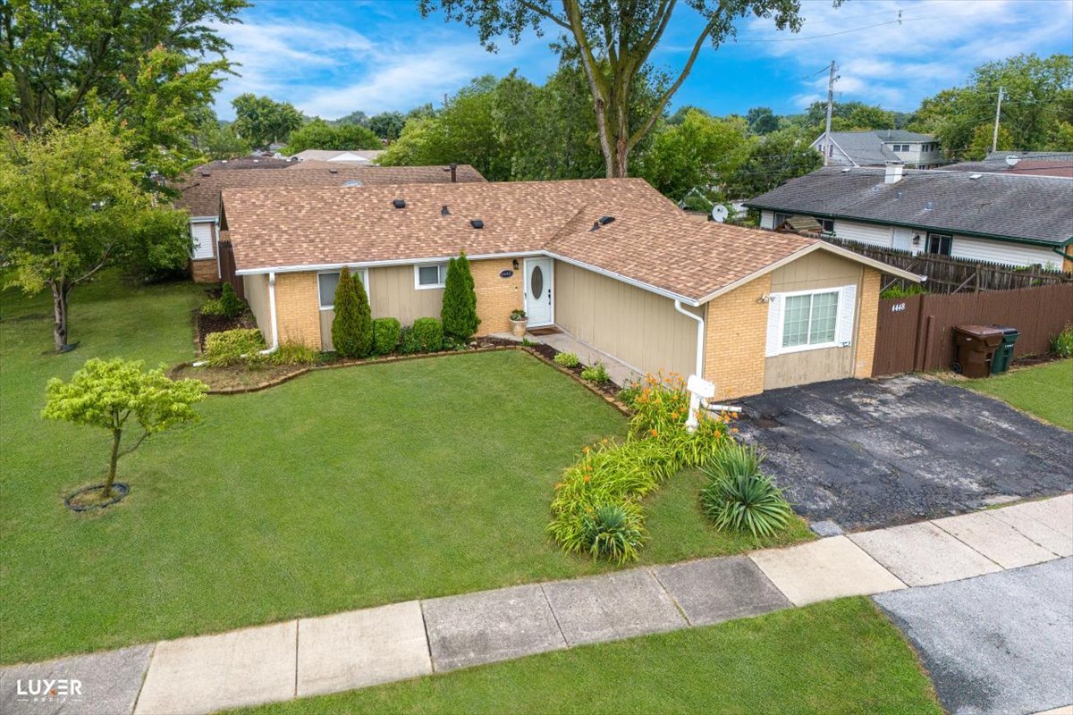 a aerial view of a house next to a yard