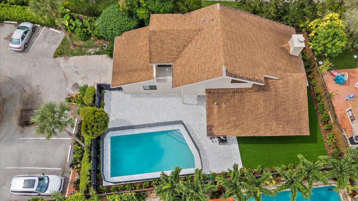 an aerial view of a house with a yard and a fountain