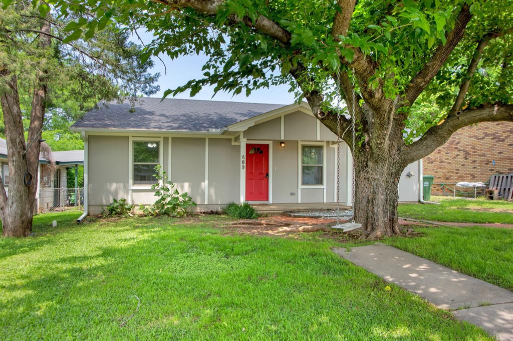 a front view of house with yard and green space