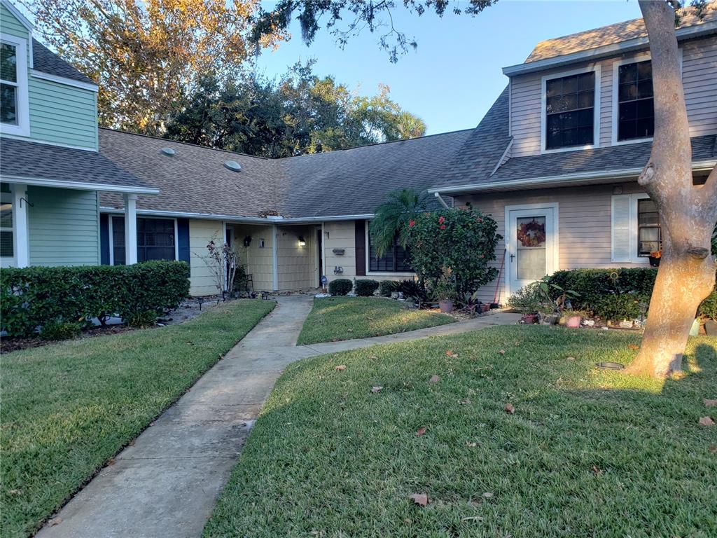 a front view of a house with garden and porch