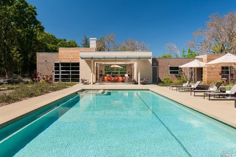 a view of a house with swimming pool yard and patio