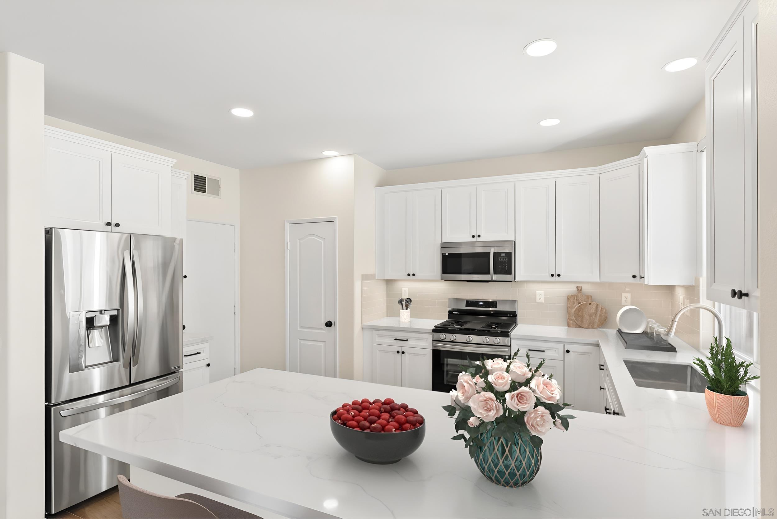 a kitchen with a refrigerator and a stove top oven