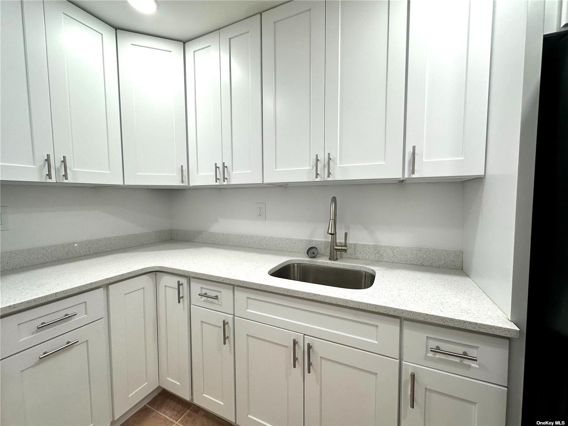 a kitchen with a sink and cabinets