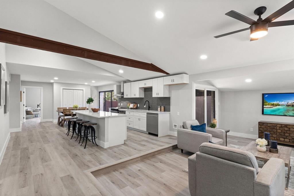 a living room with furniture and kitchen view