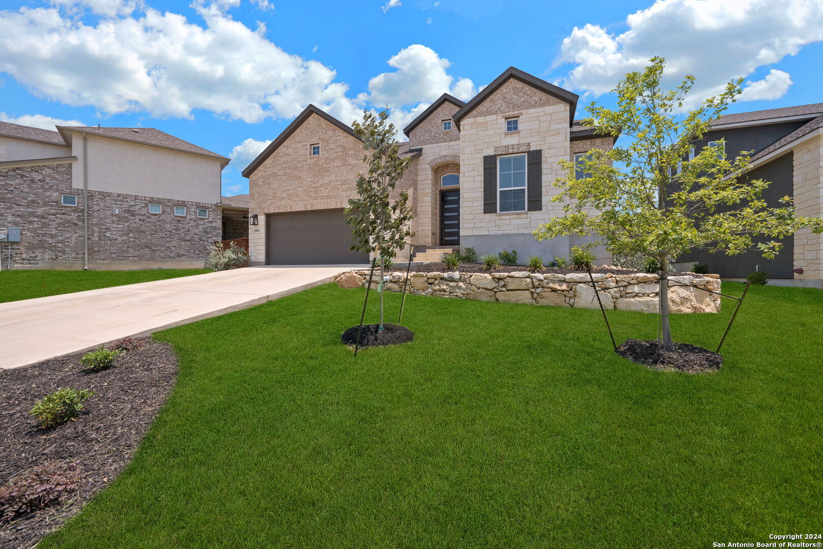 a front view of a house with a yard and garage