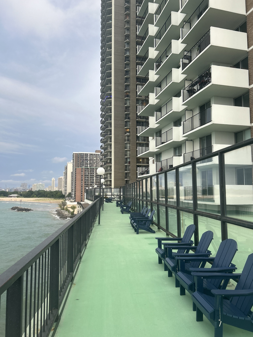 a balcony with chairs and table