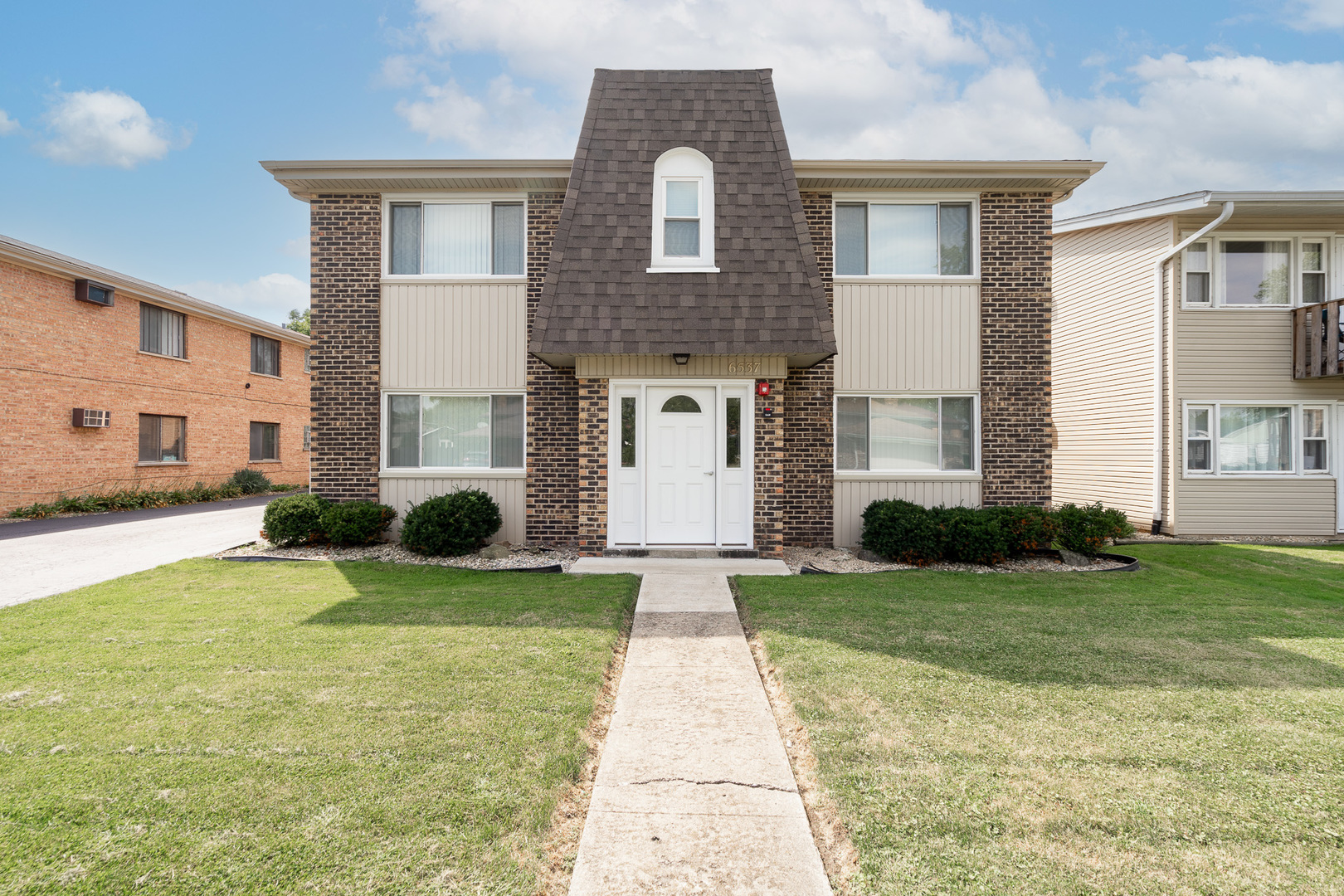 a front view of a house with a yard