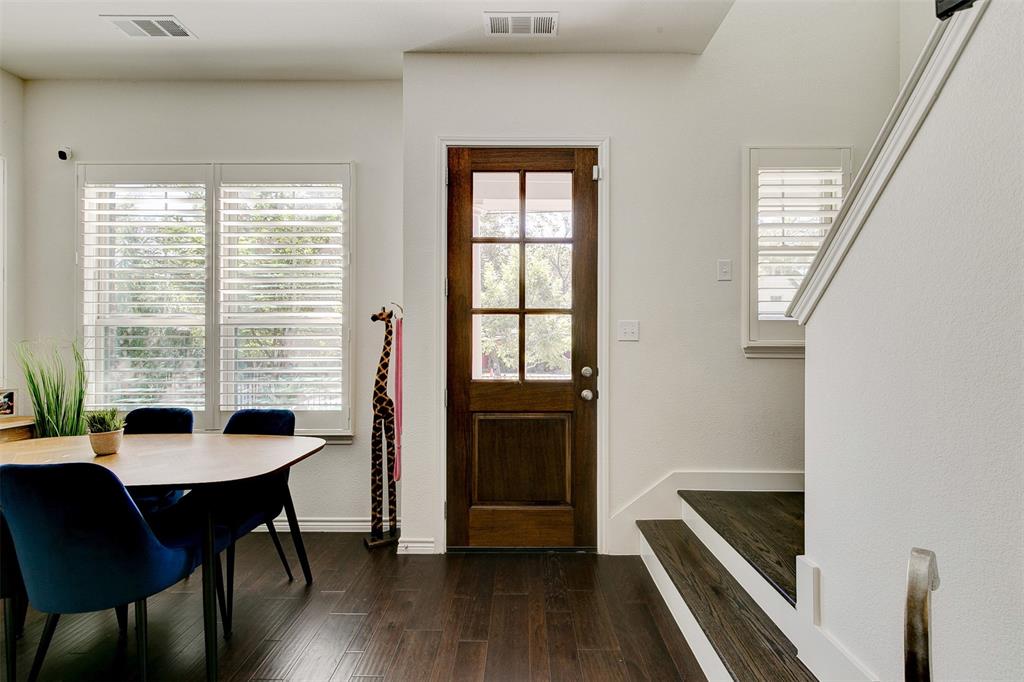 a dining room with wooden floor and furniture