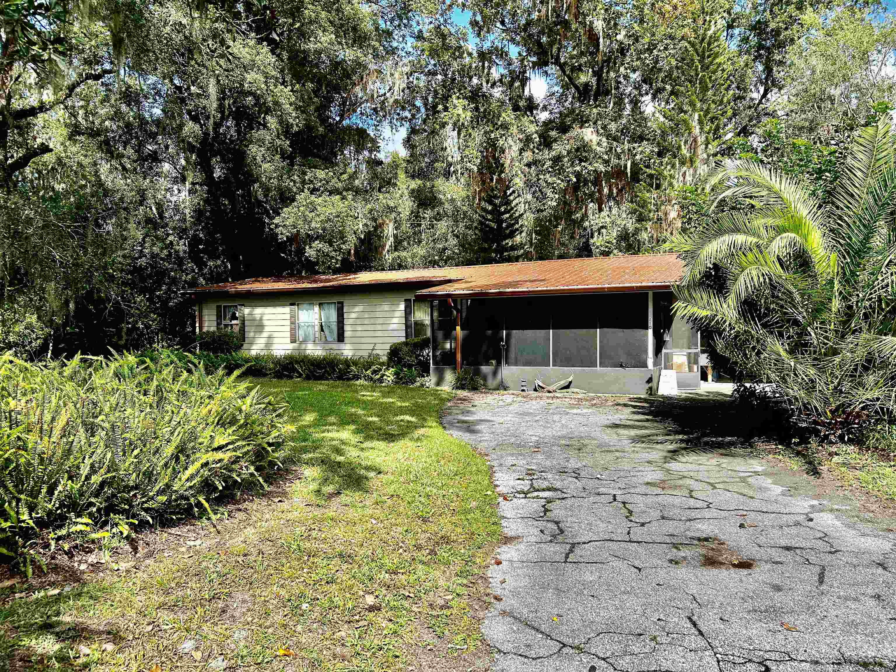 a front view of house with a garden