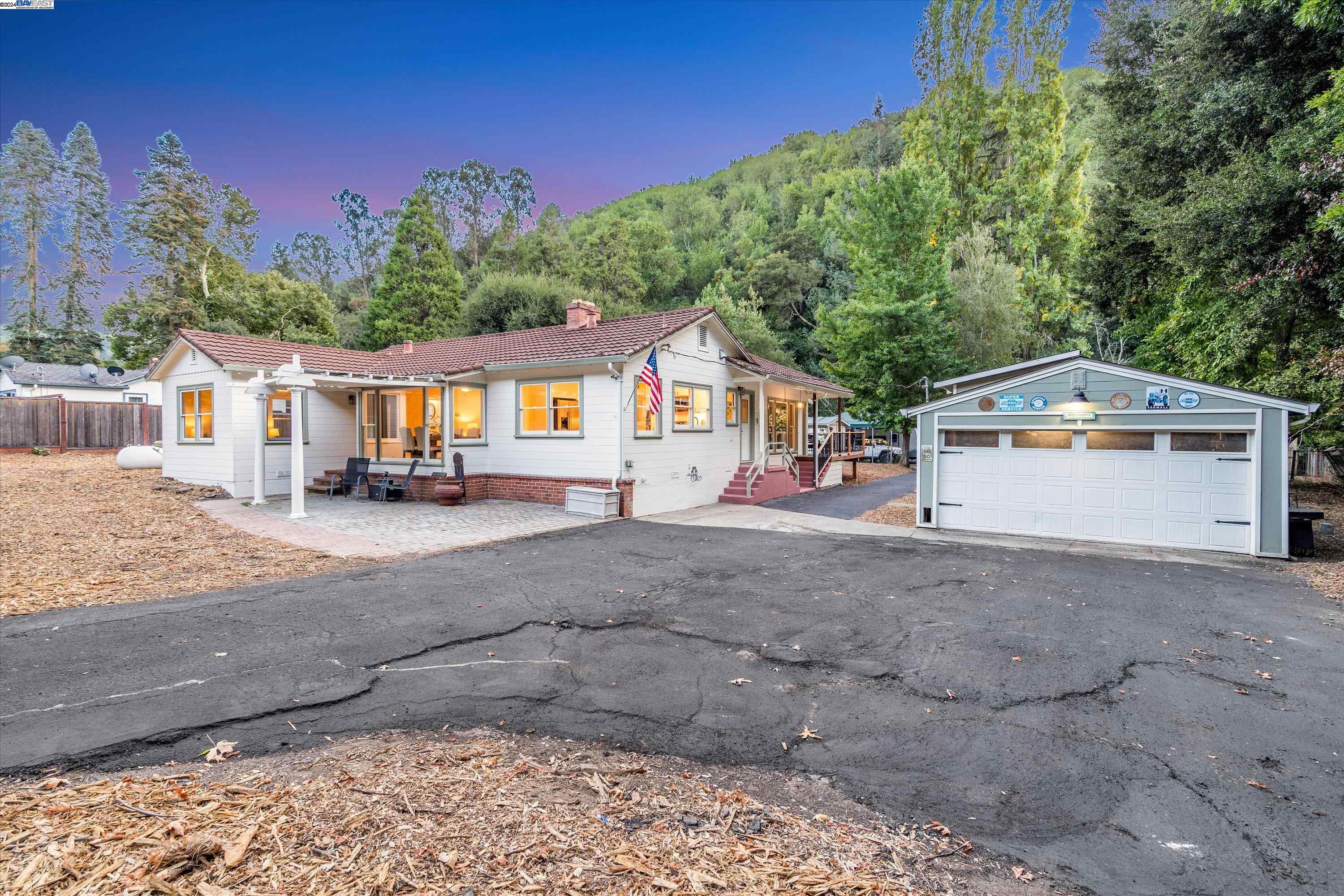 a view of house with outdoor space and parking