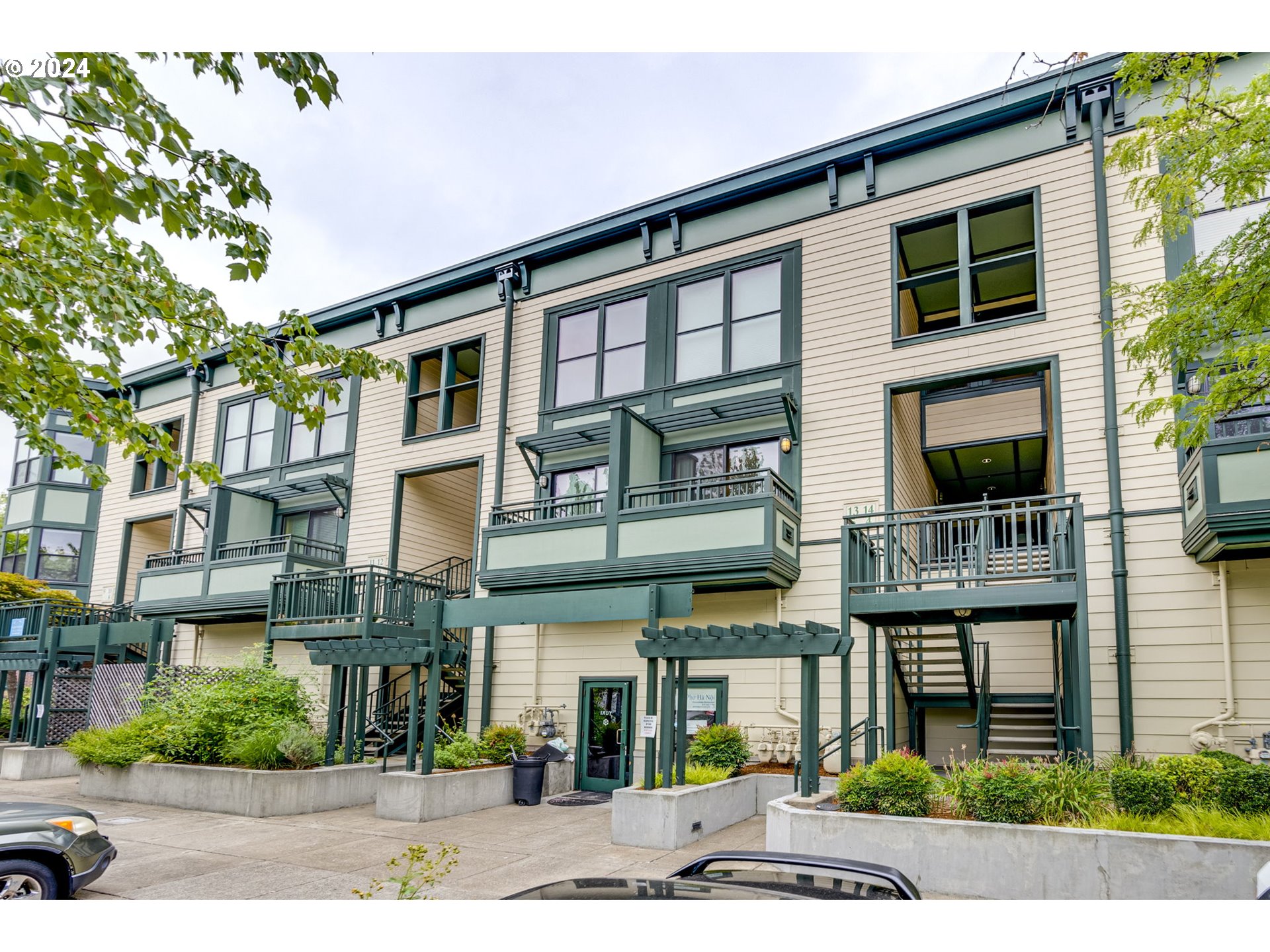 a front view of a residential apartment building with a yard