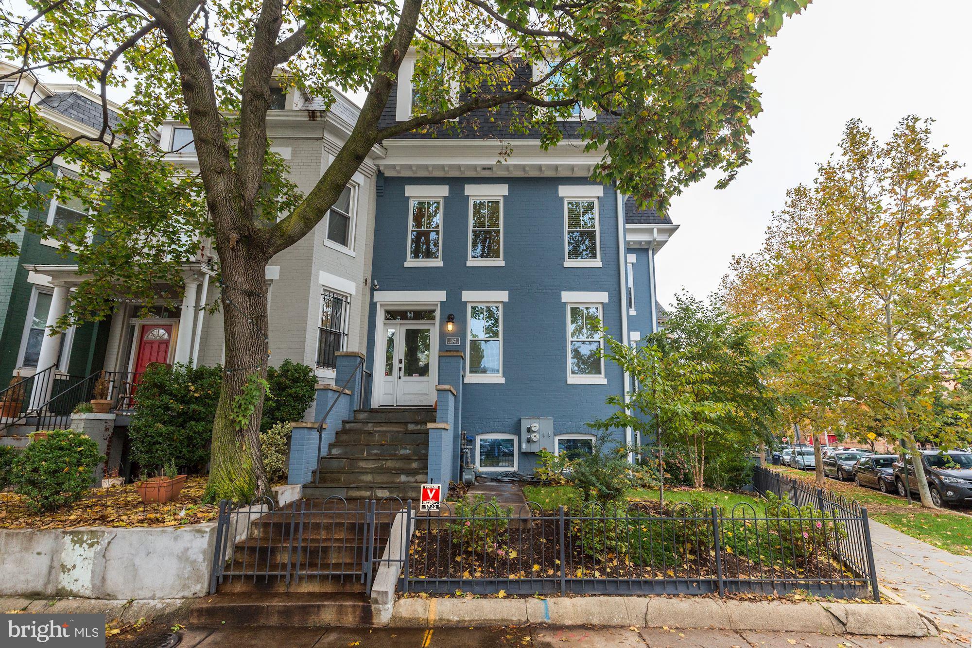 a front view of a house with trees