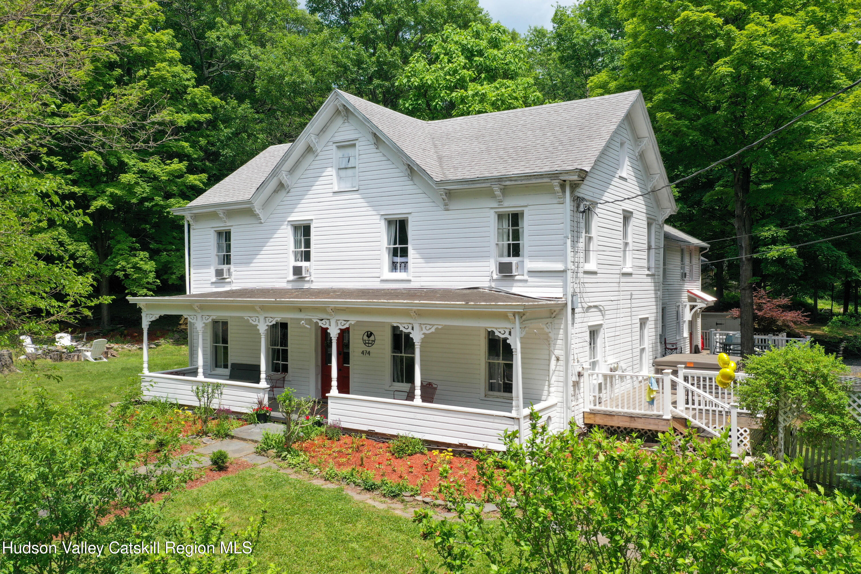 a aerial view of a house with a yard and potted plants