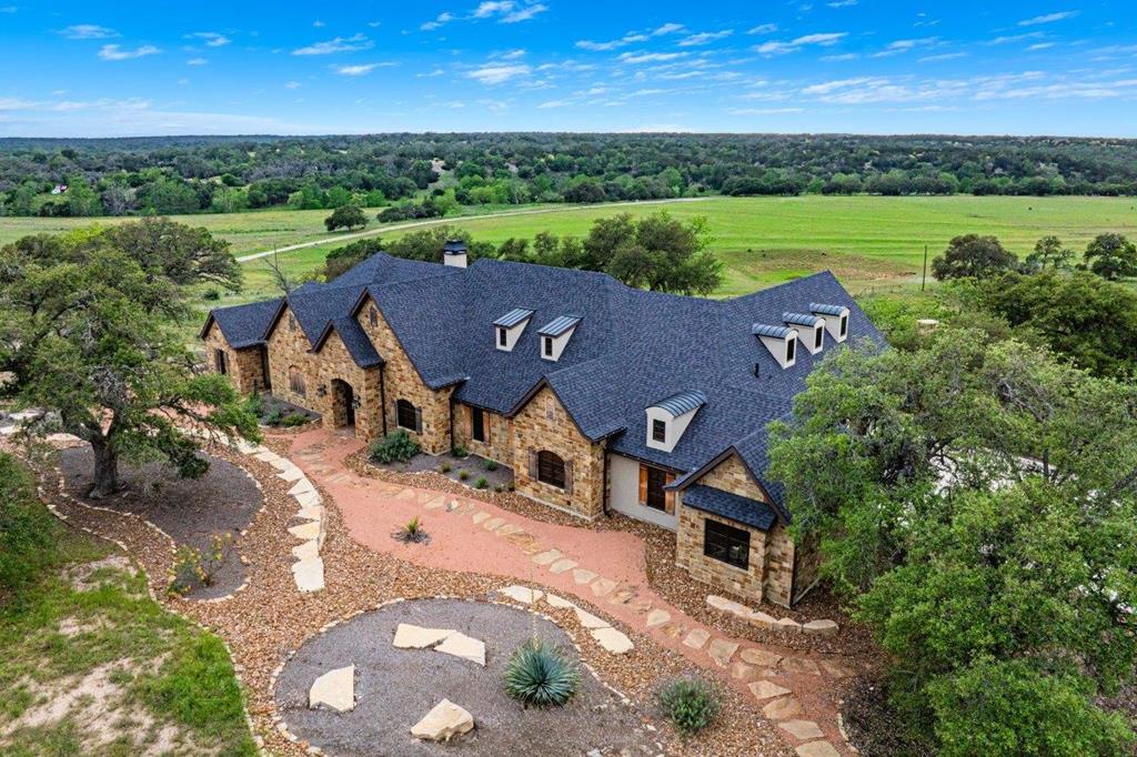 an aerial view of a house with a garden and outdoor space