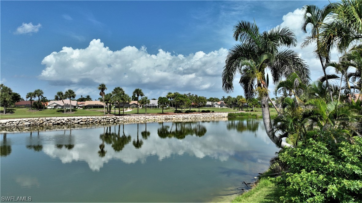 a view of a lake with houses in the back