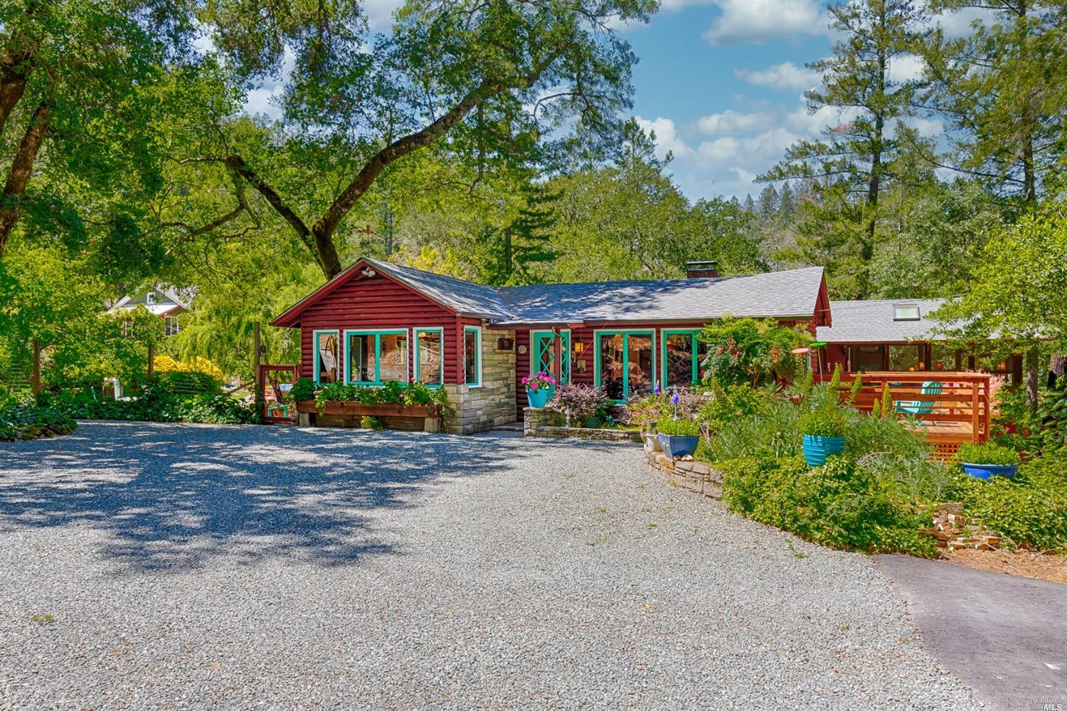 The main house has large parking area in front with a carport facing it. There is a second carport to the left.