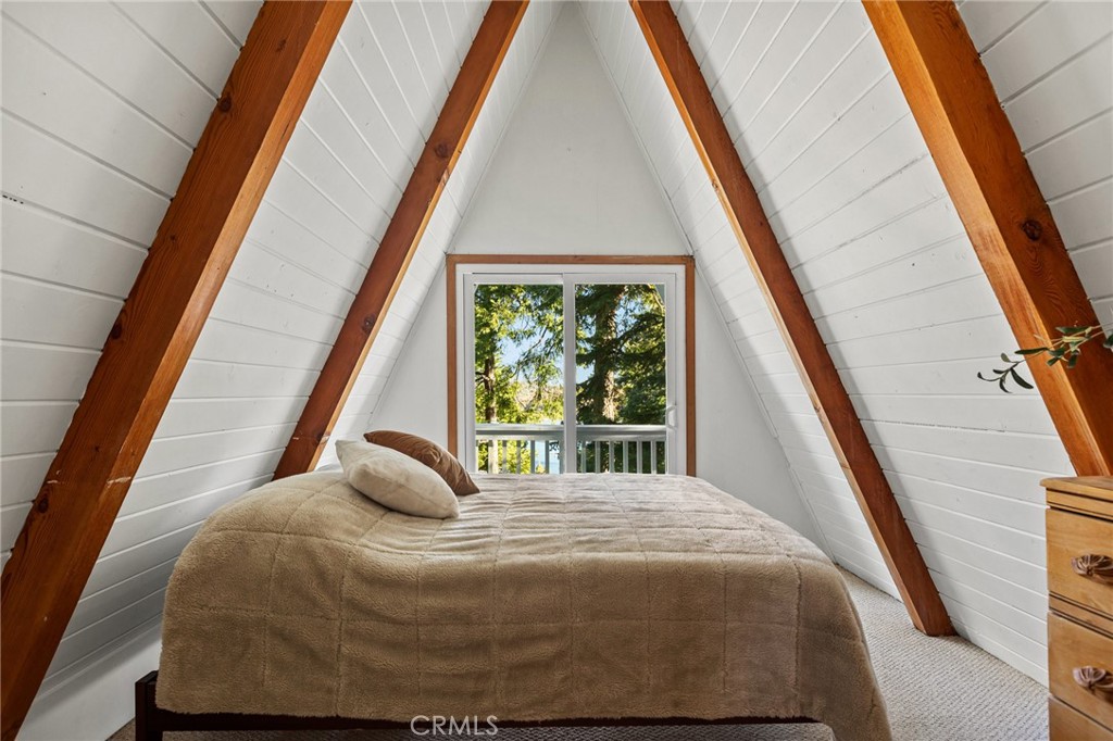 a bedroom with a bed and large window