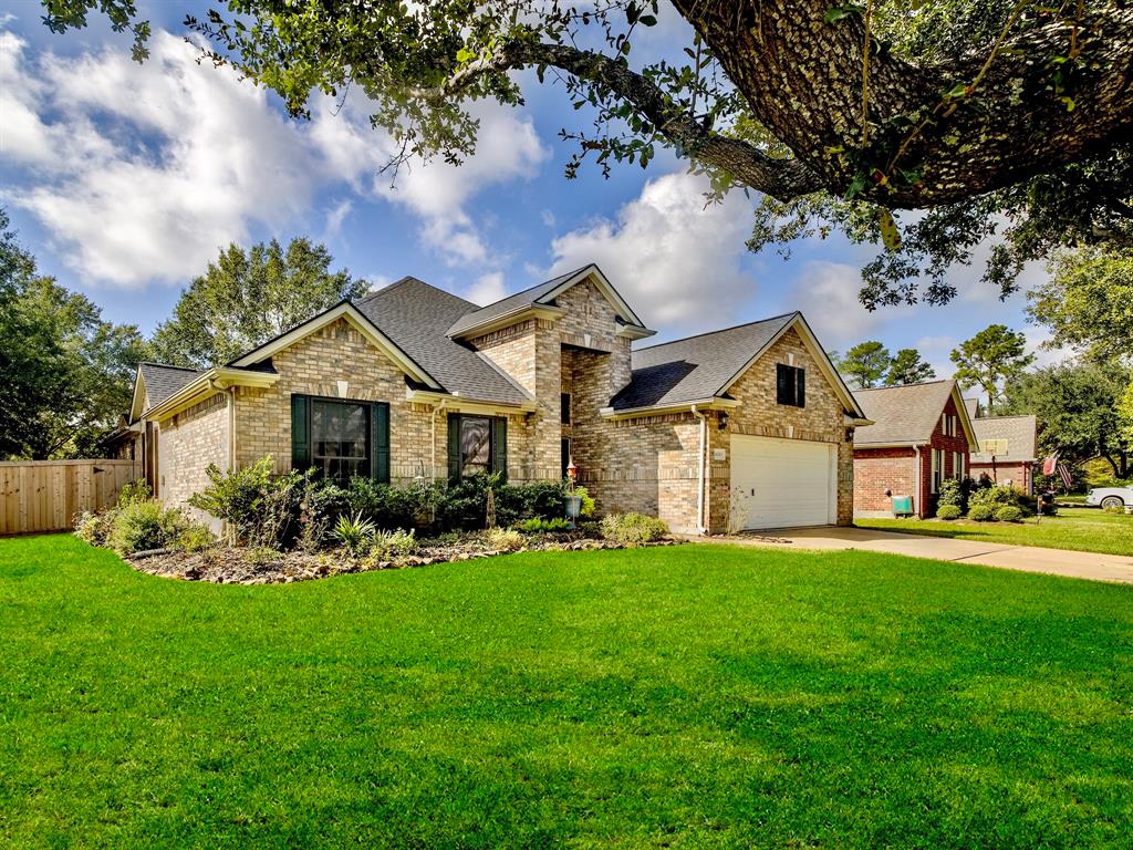 a front view of a house with a yard and trees