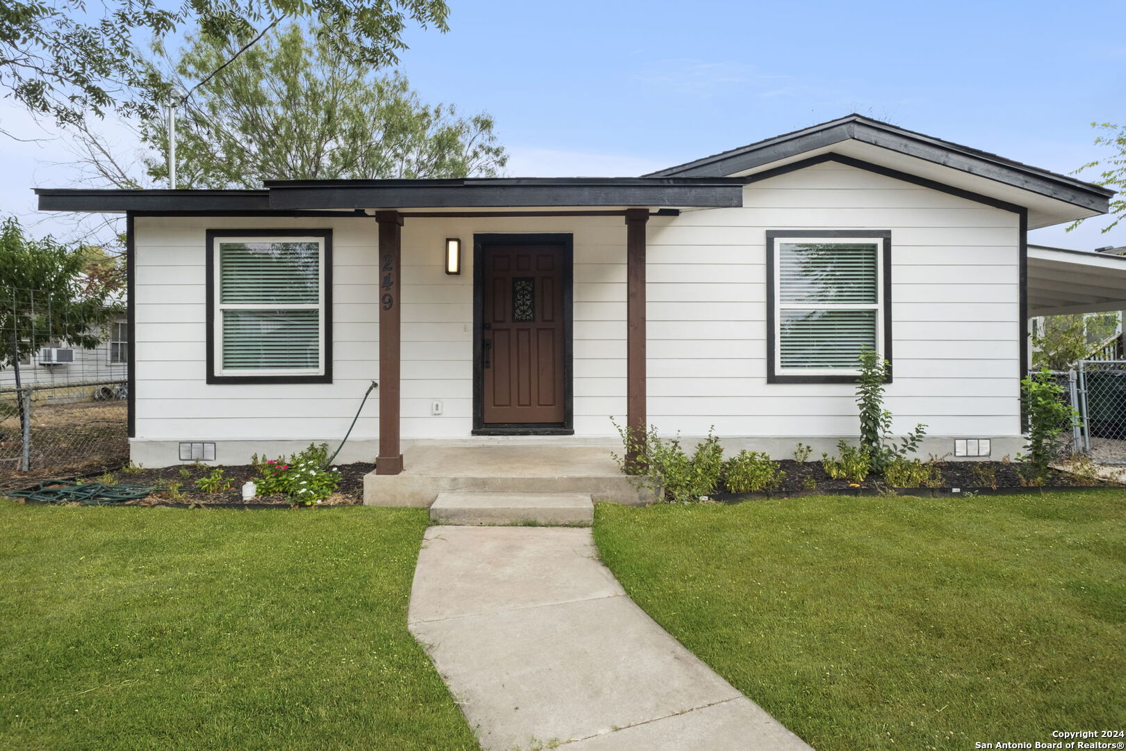 a front view of a house with a yard