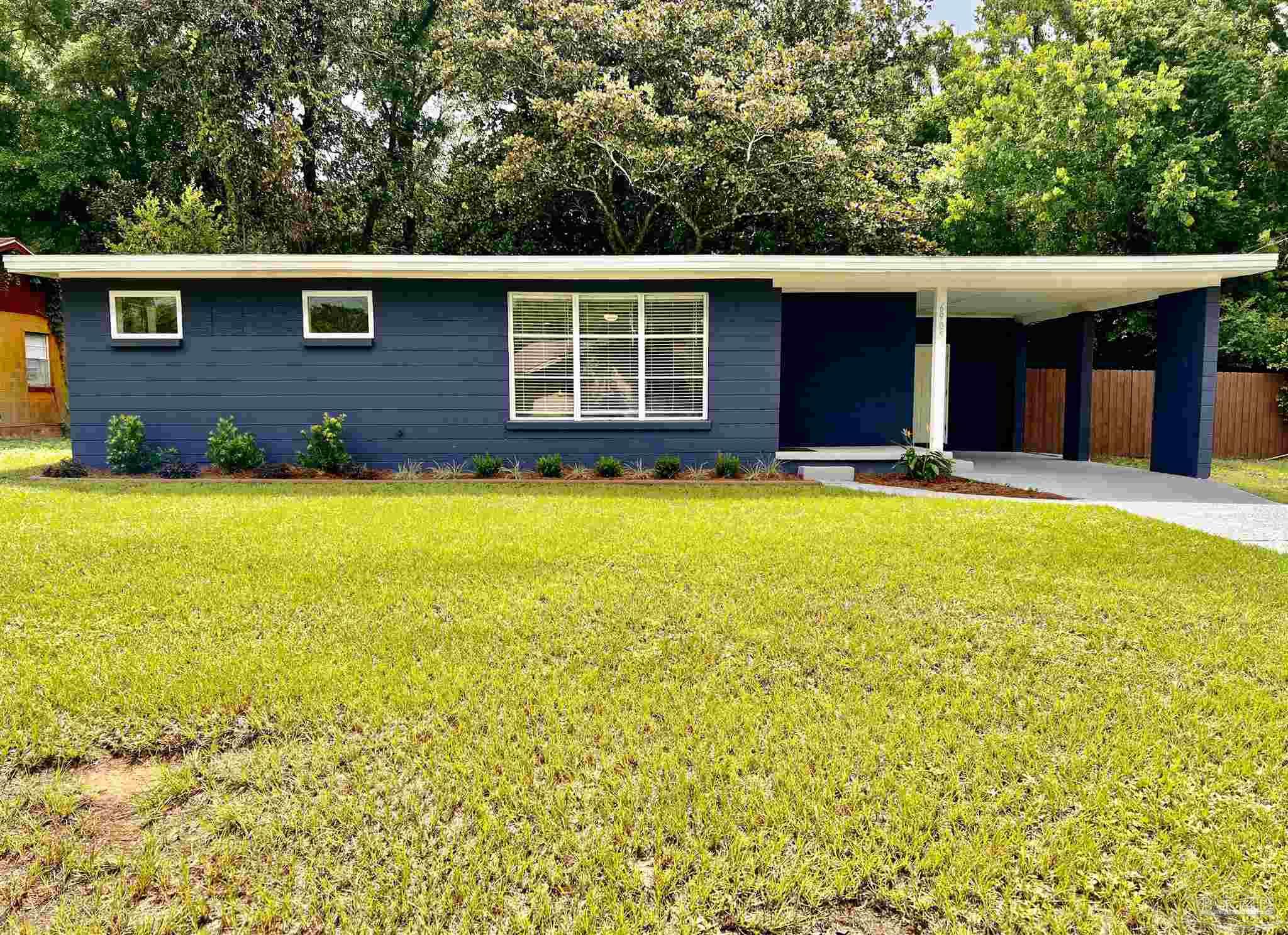 a view of a house with swimming pool in front of it