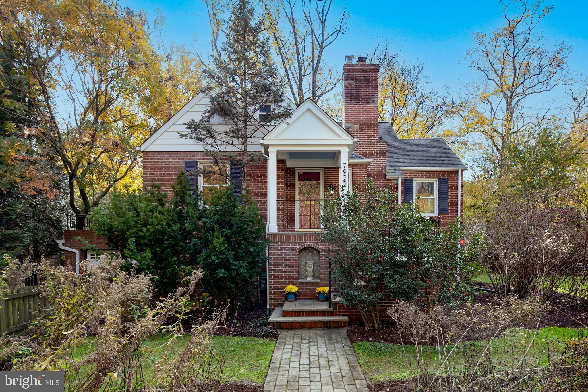 a front view of a house with trees