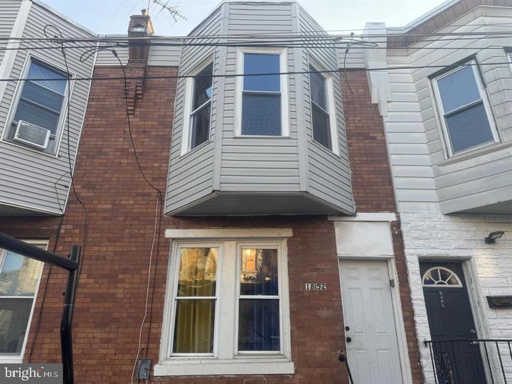 a view of a brick house with a large door