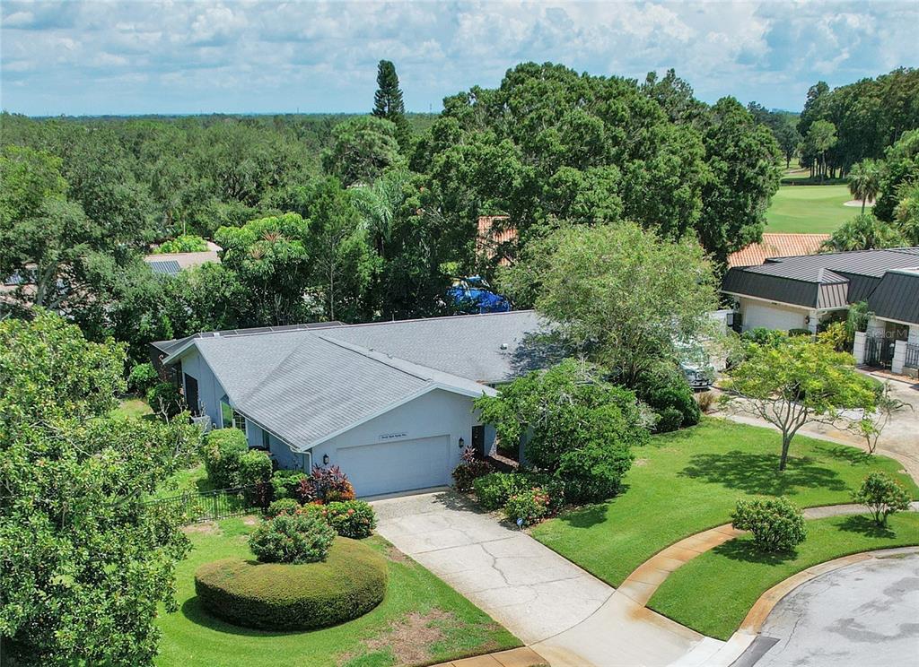 an aerial view of a house with garden space and street view