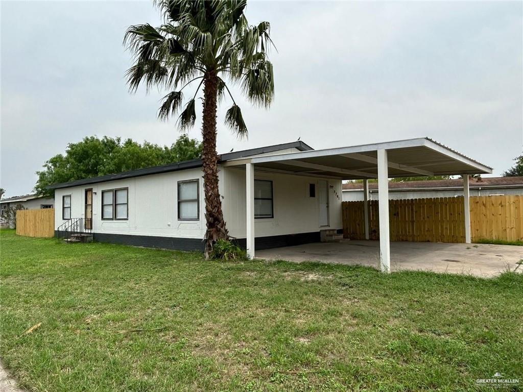 a view of a house with a backyard