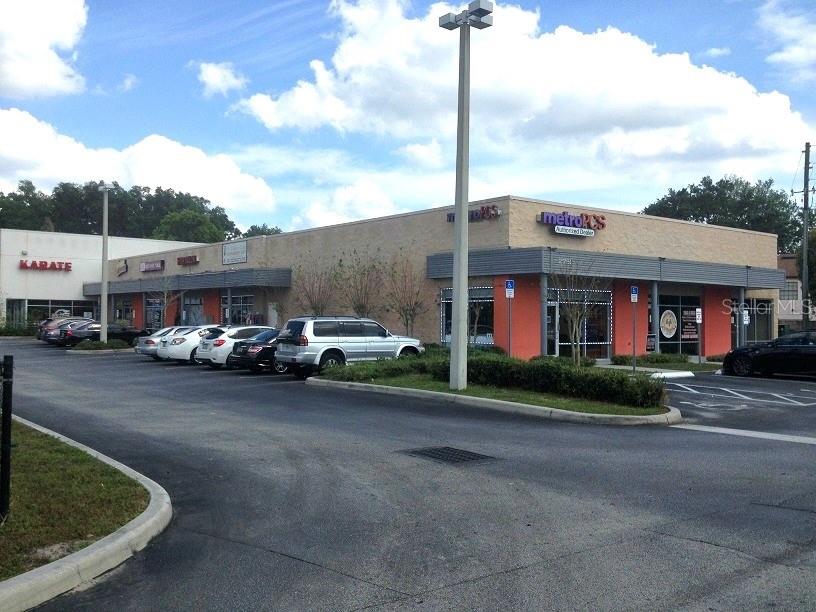 a front view of a building with parked cars