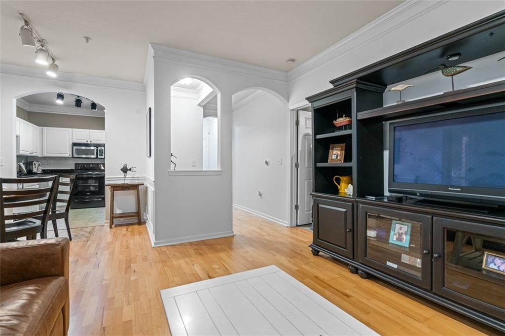 a kitchen with stainless steel appliances granite countertop a stove and a wooden floors