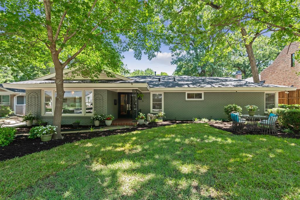 a view of a house with a yard and a patio