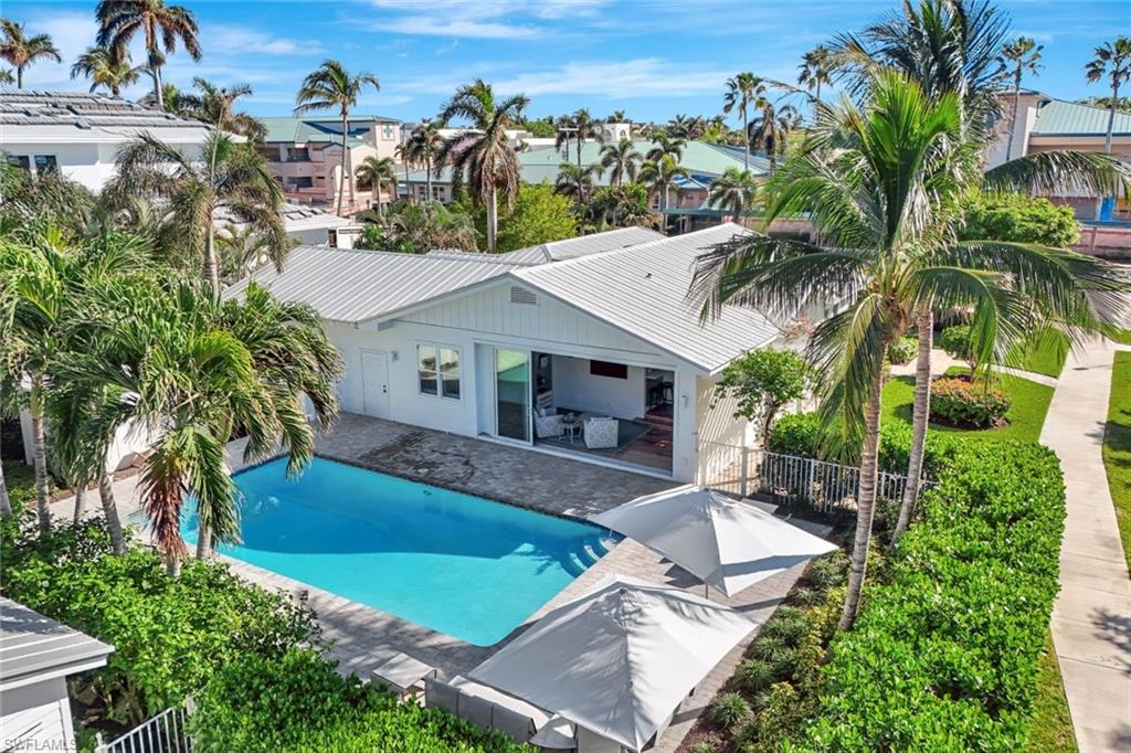 an aerial view of a house with swimming pool garden and patio