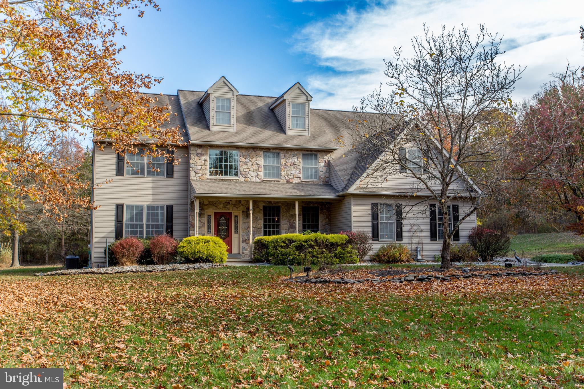 a front view of house with yard and trees around