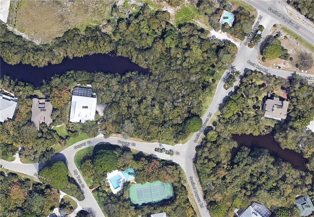 an aerial view of a house a yard and mountain