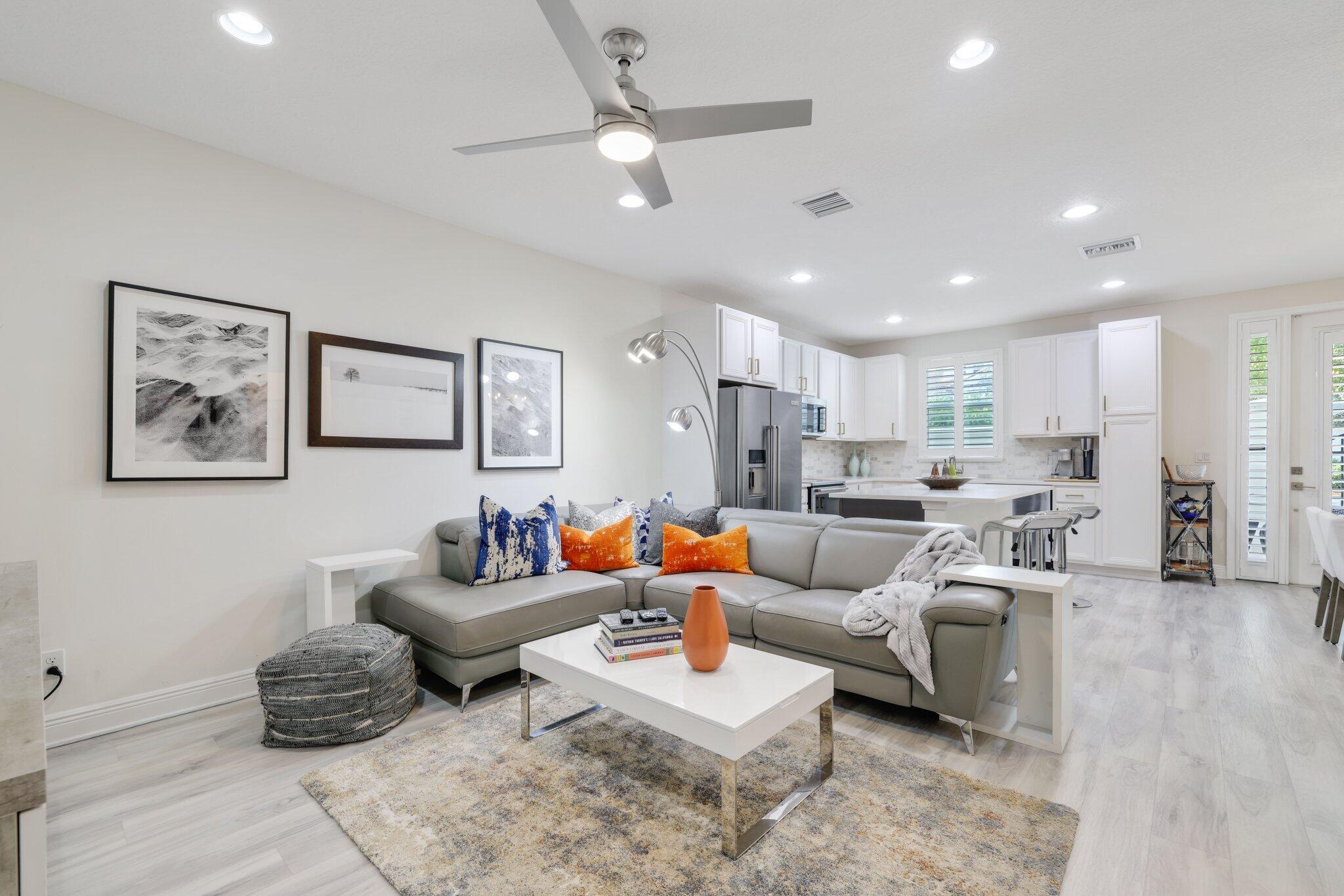 a living room with furniture and a view of kitchen