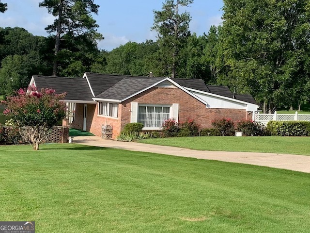 a front view of a house with a garden