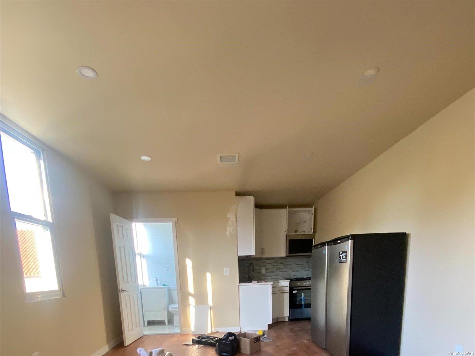 a kitchen with stainless steel appliances a refrigerator and a stove top oven