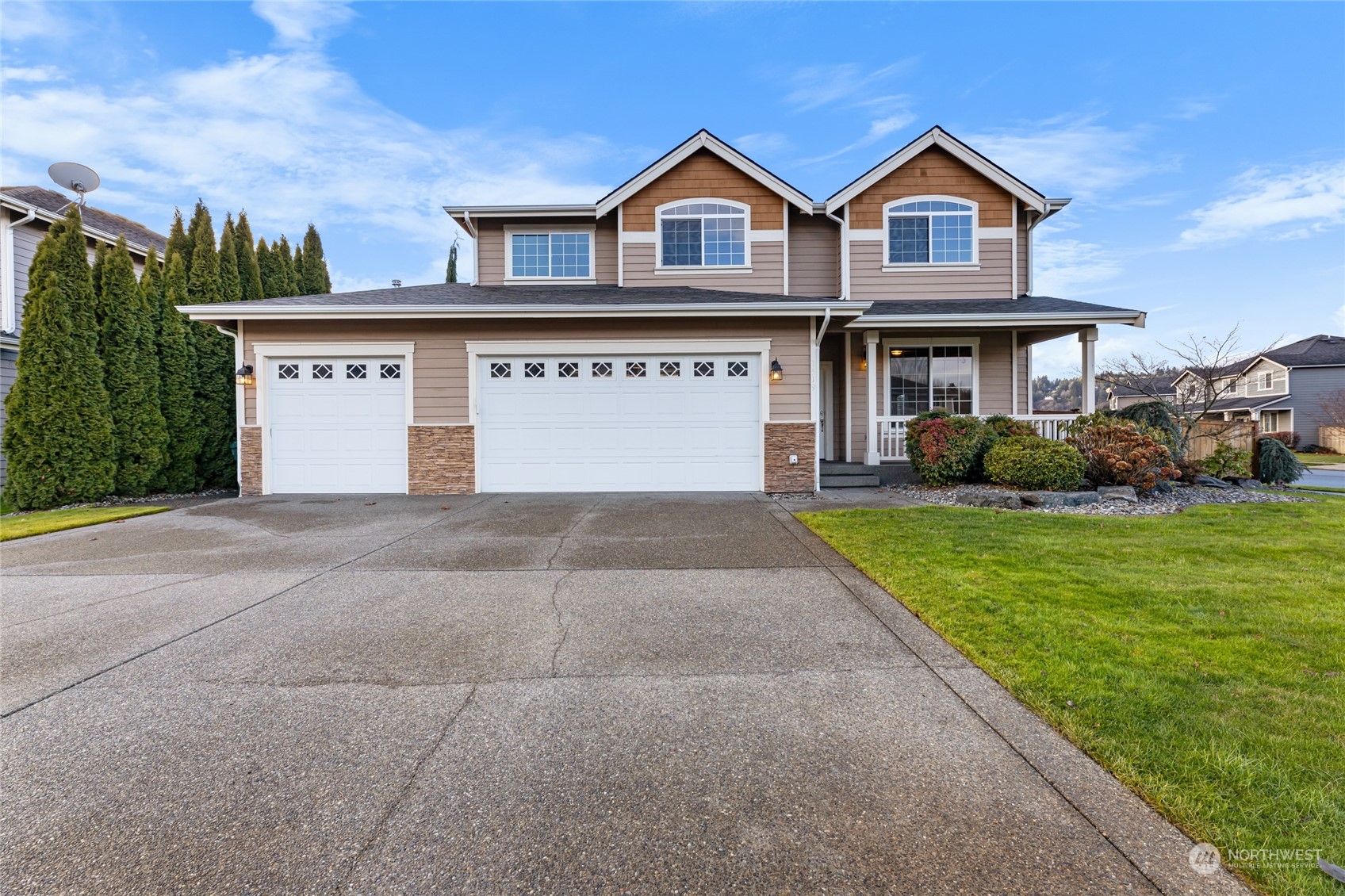 a front view of a house with a yard and garage