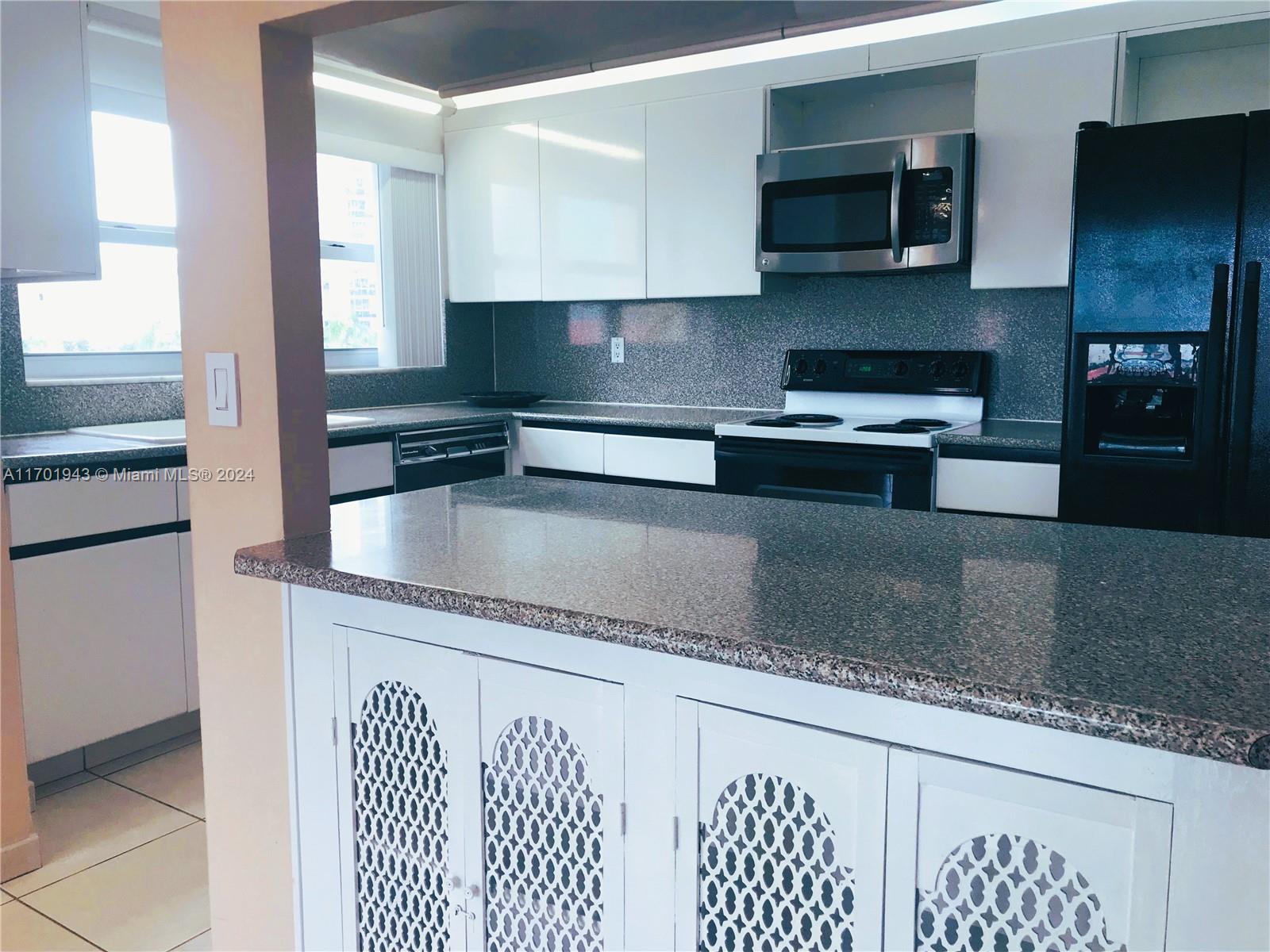 a kitchen with stainless steel appliances granite countertop a sink and a stove