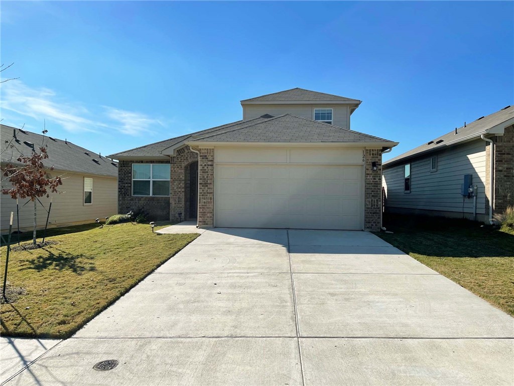 a front view of a house with a yard