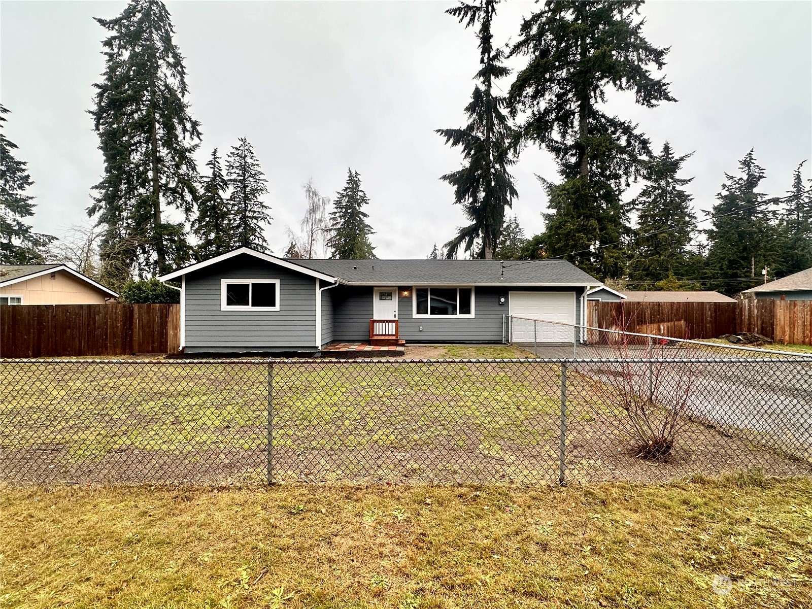 a front view of a house with a yard covered with snow in front of it