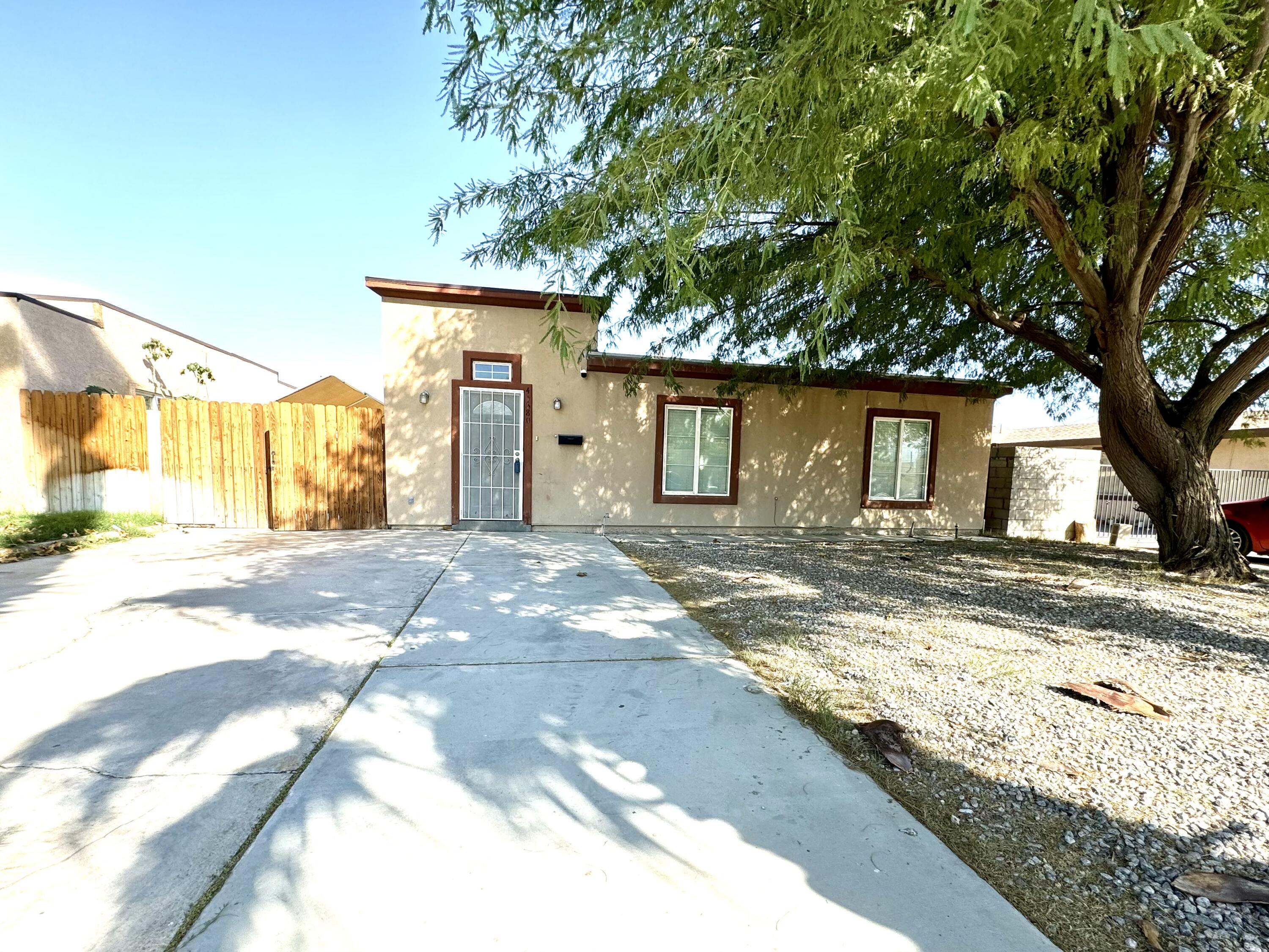 a view of a house with a tree in the background