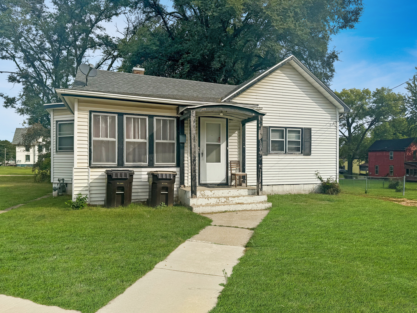 a front view of house with yard and green space